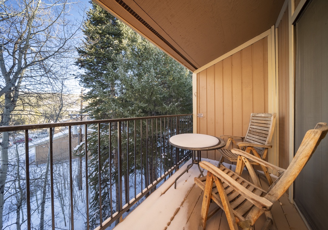 Step onto your private balcony where warm wood meets winter wonderland—sip morning coffee while snow-dusted evergreens frame your peaceful retreat.