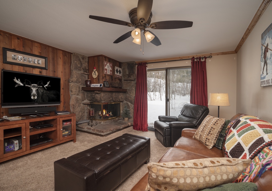 Cozy up by your stone fireplace while snow falls outside, creating the perfect mountain retreat atmosphere.