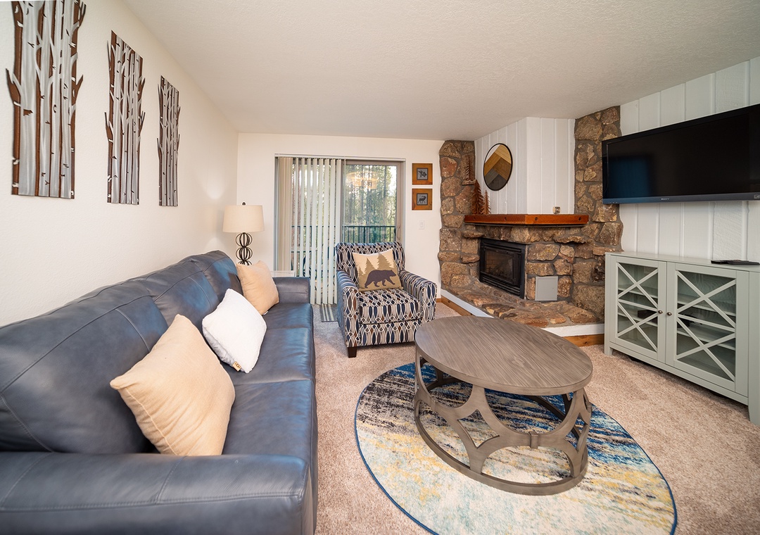 Sink into the plush leather sofa while your fireplace crackles nearby, creating the perfect backdrop for cozy evenings watching your favorite shows.
