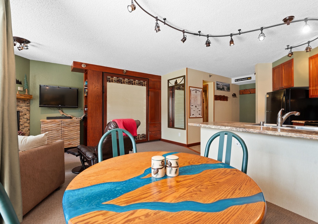 Relax in your open-concept living space with a fully equipped kitchen, cozy seating, and a welcoming dining area—perfect for unwinding after a day of adventure.