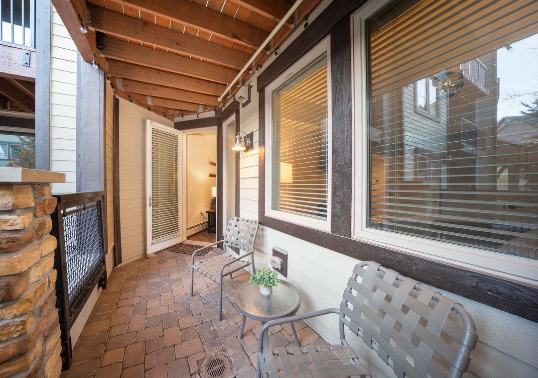 This charming covered patio offers your own peaceful retreat with comfortable seating and warm lighting—perfect for morning coffee or unwinding after a day of adventure.