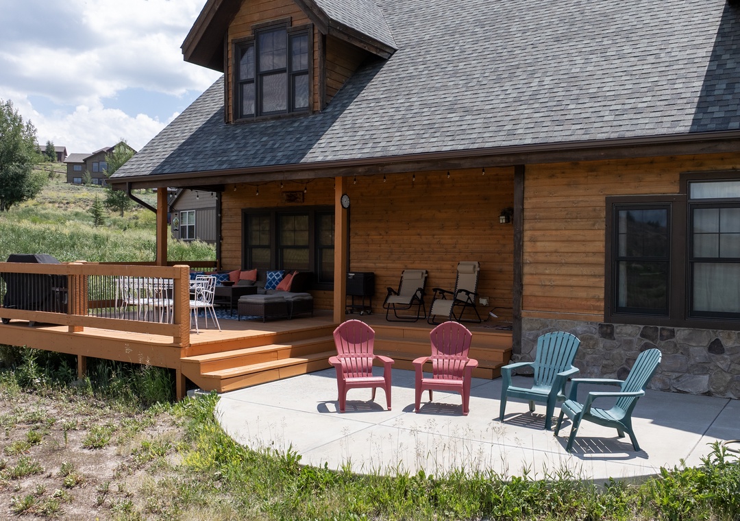Charming mountain cabin with spacious deck and colorful Adirondack chairs for your perfect outdoor retreat.