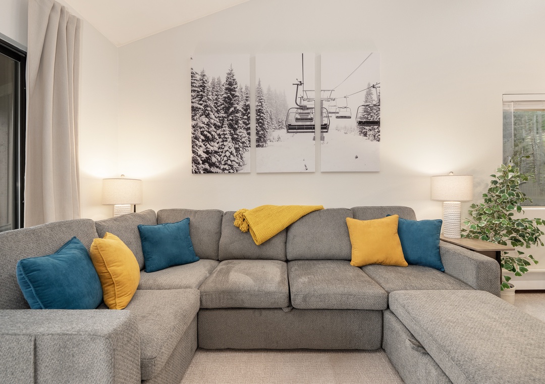 Sink into this plush sectional with vibrant pillows and unwind beneath mountain-inspired art after your alpine adventures.