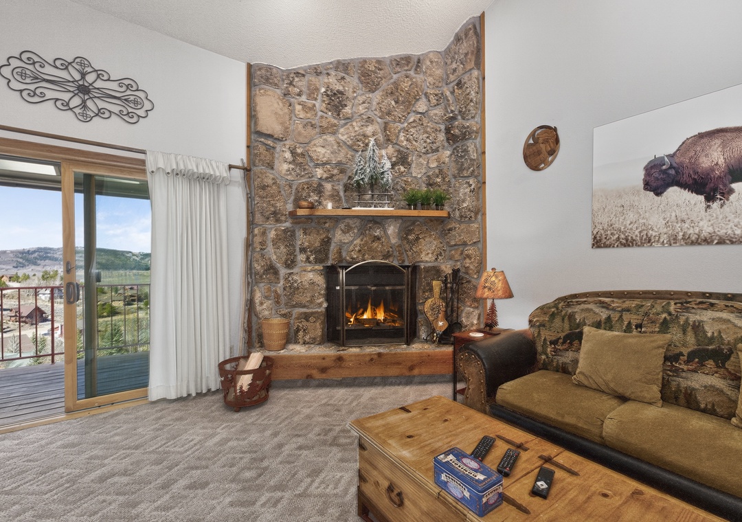 Cozy up by your crackling stone fireplace while taking in mountain views from your private balcony—perfect for unwinding after adventure-filled days.
