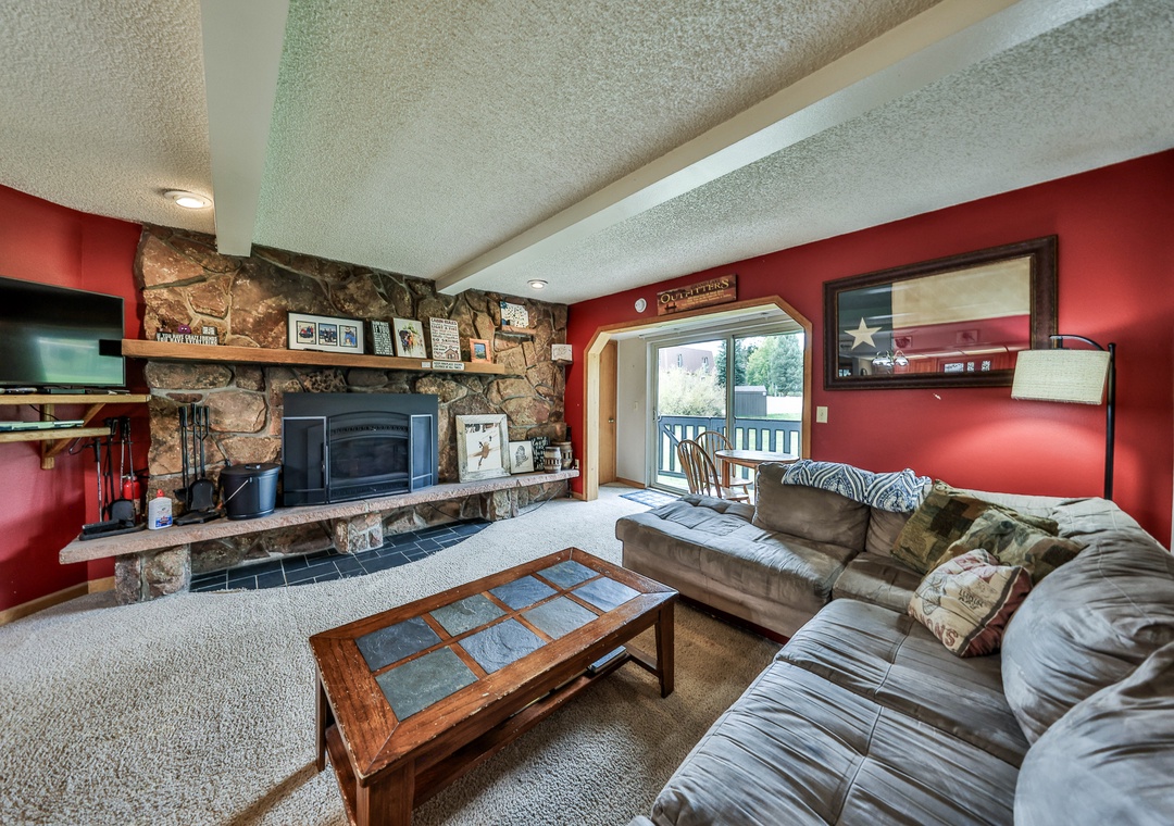 Cozy up in your spacious living room with plush leather seating, warming fireplace, and entertainment center for perfect mountain retreat evenings.