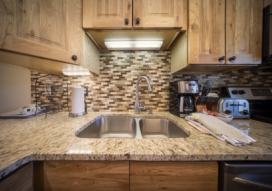 Your fully equipped kitchen awaits with granite counters, stainless appliances, and warm wood cabinets—perfect for preparing meals together.