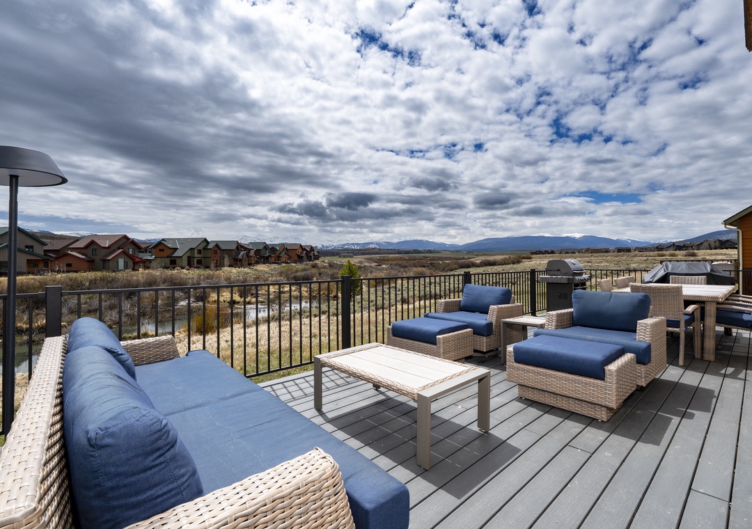 Spacious deck overlooking mountain vistas and open landscape, perfect for morning coffee or evening relaxation with comfortable outdoor seating and peaceful views.