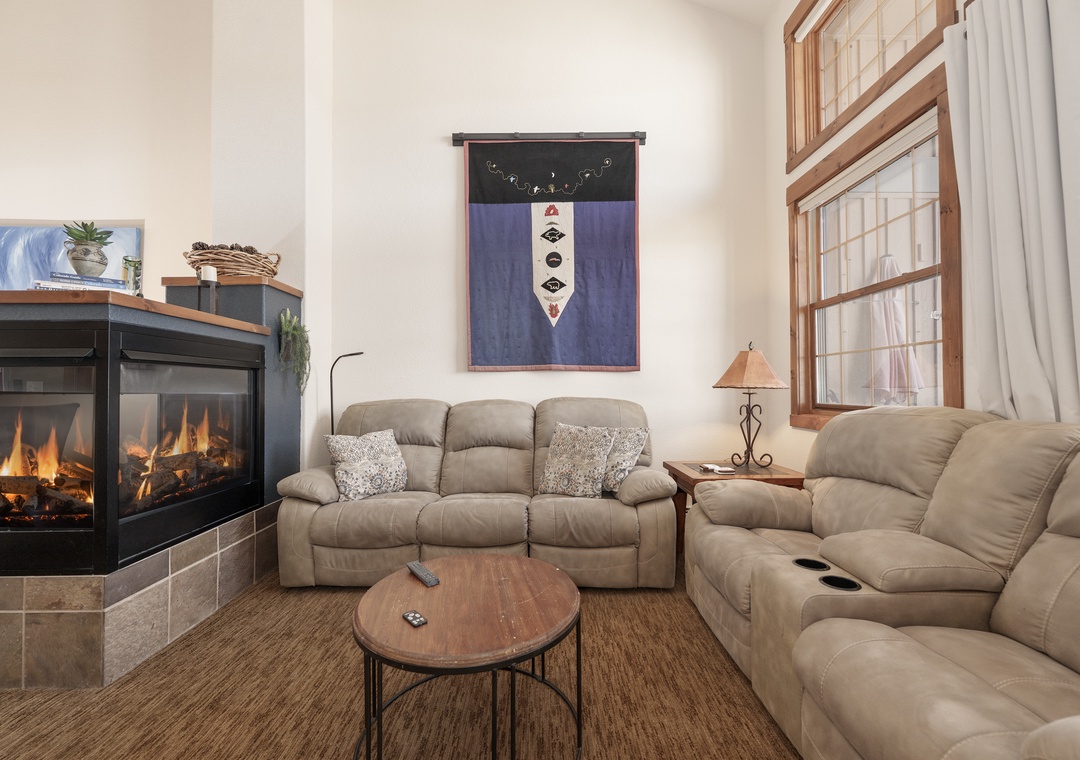Sink into plush recliners at Kicking Horse Palomino 7-302 by your cozy fireplace, where warm flames create the perfect ambiance for relaxation.