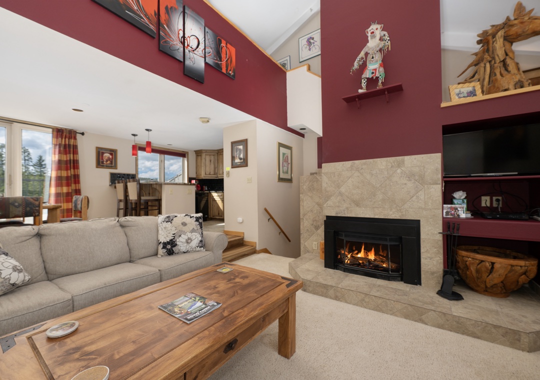 Cozy up in your spacious living room where crackling flames and mountain views create the perfect retreat after a day of adventure.