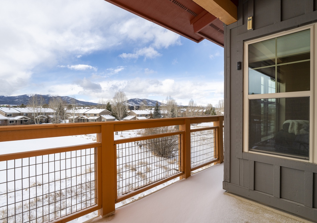 Step onto your private balcony and soak in breathtaking mountain views while winter snow blankets the peaceful neighborhood below.