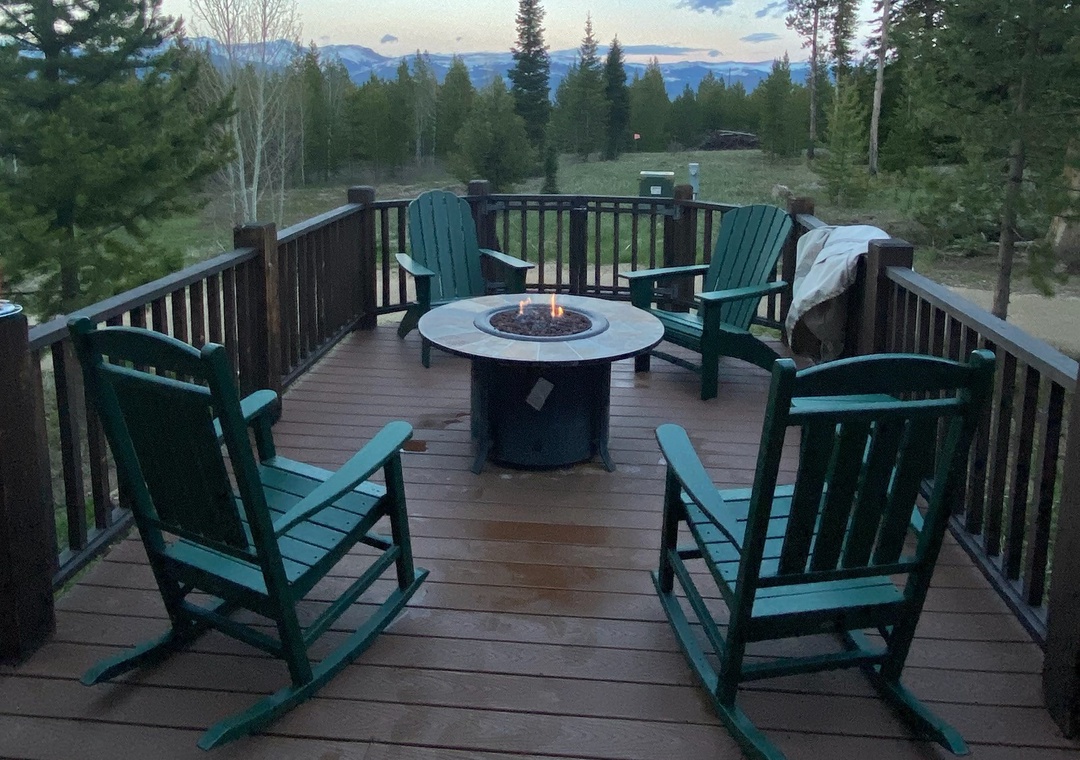 Gather around this cozy fire pit with mountain views stretching beyond the forest canopy.