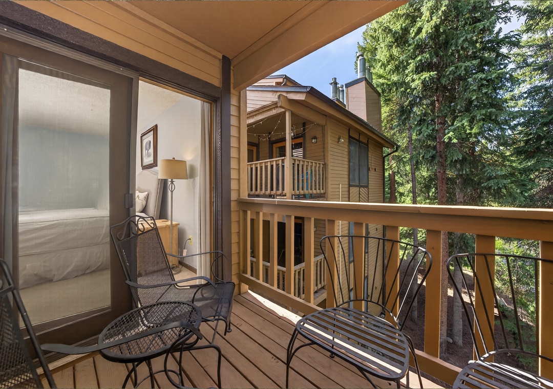 Step onto your private balcony and unwind in the fresh mountain air, surrounded by towering evergreens and peaceful forest views.