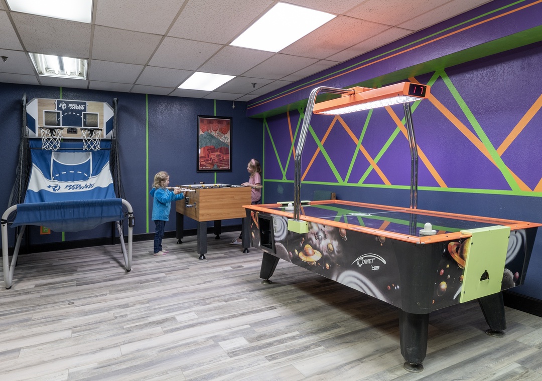 Challenge your friends to a game of air hockey or test your basketball skills in this vibrant entertainment space designed for friendly competition and fun.
