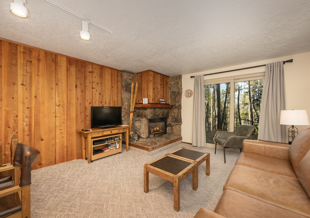 Cozy up by your crackling stone fireplace while enjoying tree views from your comfortable leather seating.
