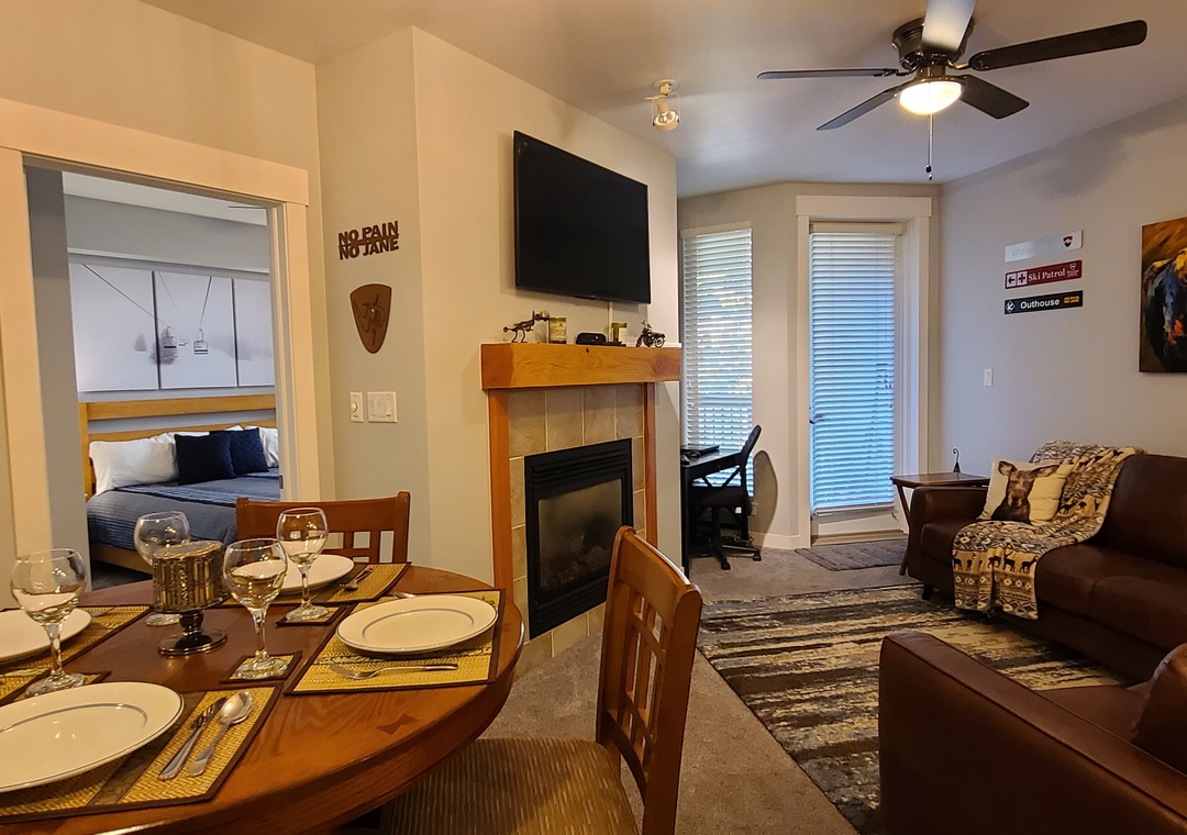 Unwind in your cozy living space featuring a warm fireplace, comfortable seating, and dining for memorable evenings together.