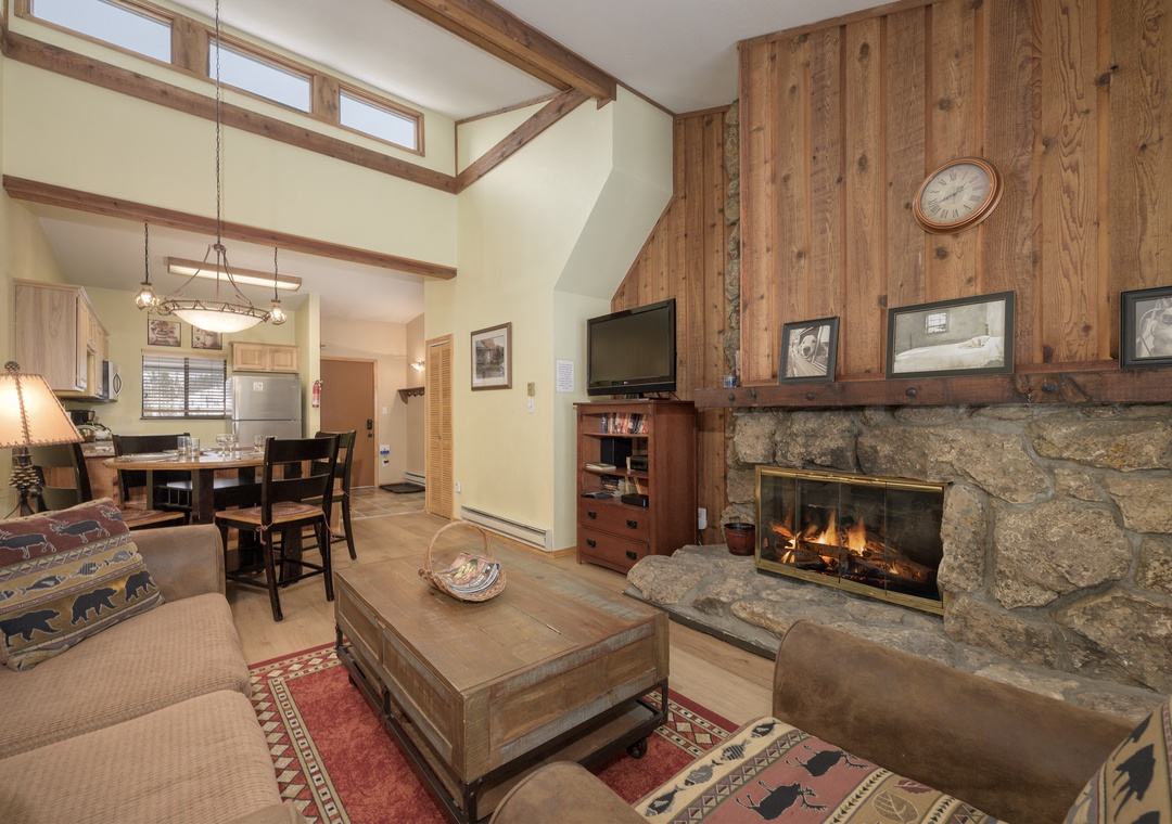 Cozy up by your stone fireplace while natural light streams through vaulted ceilings in this warm mountain retreat.