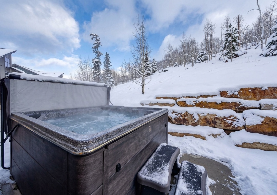 Soak your cares away in the steaming hot tub while surrounded by pristine snow and towering pines—your private winter retreat awaits with breathtaking mountain views.