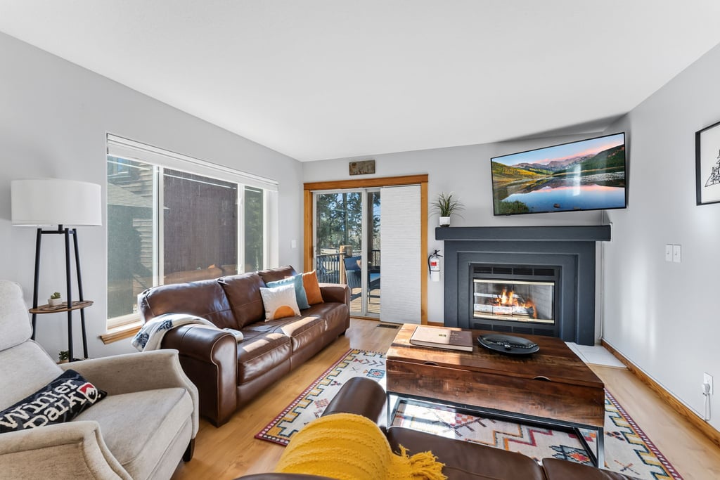 Cozy up by your crackling fireplace with plush leather seating and mountain views on the smart TV for perfect evenings.