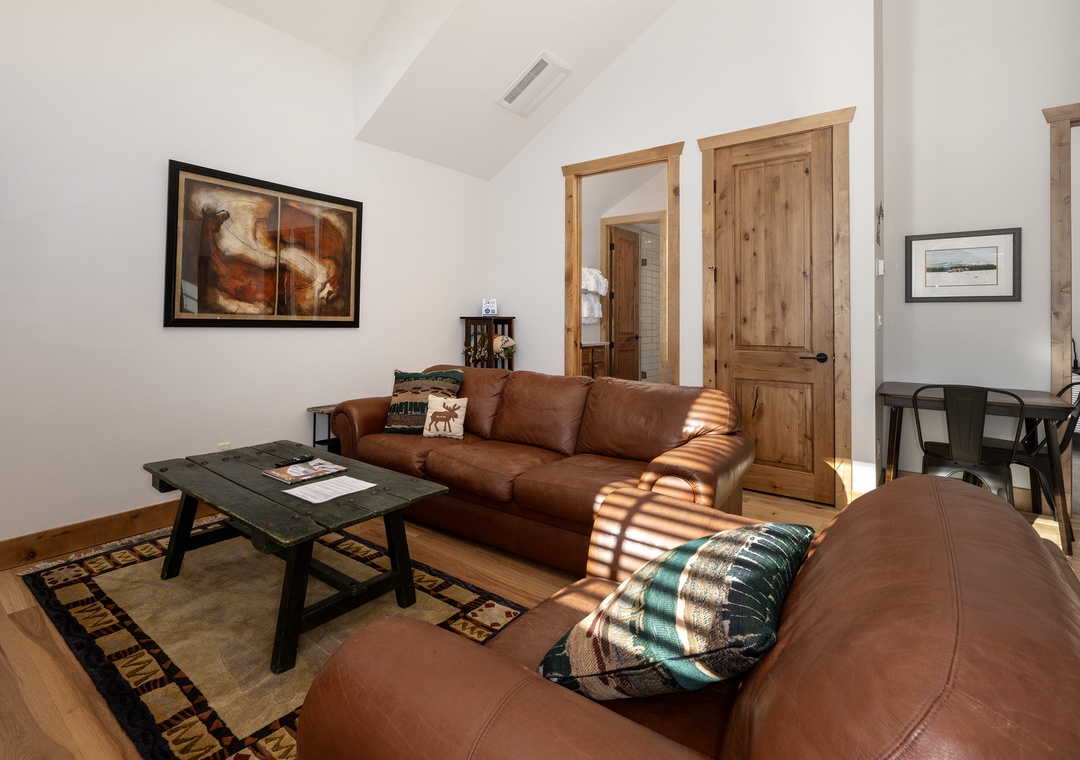 Sink into rich leather seating where warm sunlight streams through, creating the perfect spot for your morning coffee or evening relaxation.