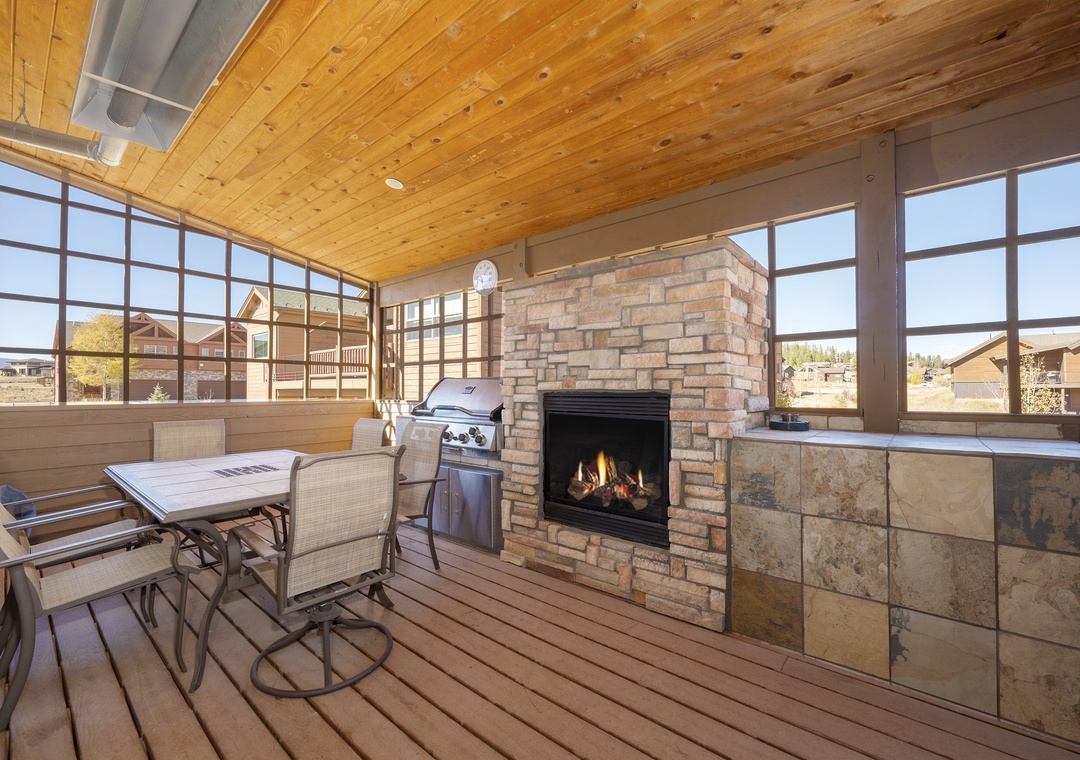 Gather around your private fireplace while dinner sizzles on the grill in this stunning covered terrace with mountain views.