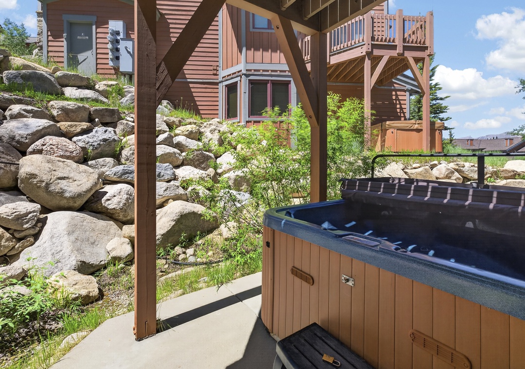 Soak under the open sky in your private hot tub, surrounded by natural boulders and mountain greenery. The perfect outdoor retreat after a day of adventure.