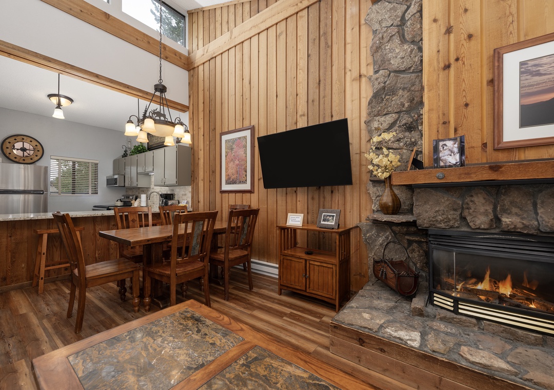 Cozy up by your crackling stone fireplace while enjoying mountain lodge comfort with warm wood accents and open-concept living.