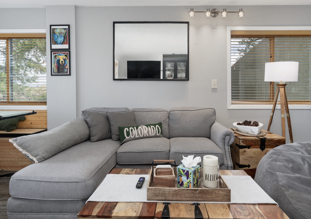 Sink into the plush sectional sofa where you'll unwind with your favorite shows on the wall-mounted TV in this thoughtfully designed living space.
