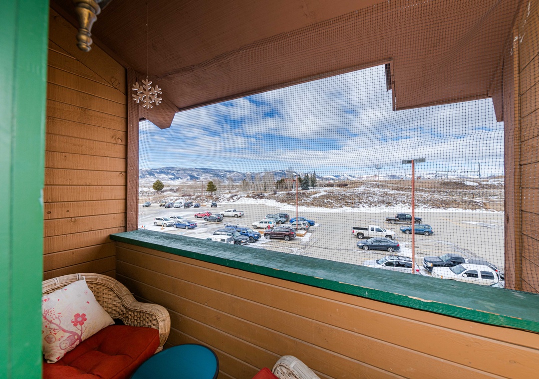 Your private mountain balcony at 645 SilverCreek Inn offers stunning snow-capped views and colorful seating for morning coffee or evening relaxation.