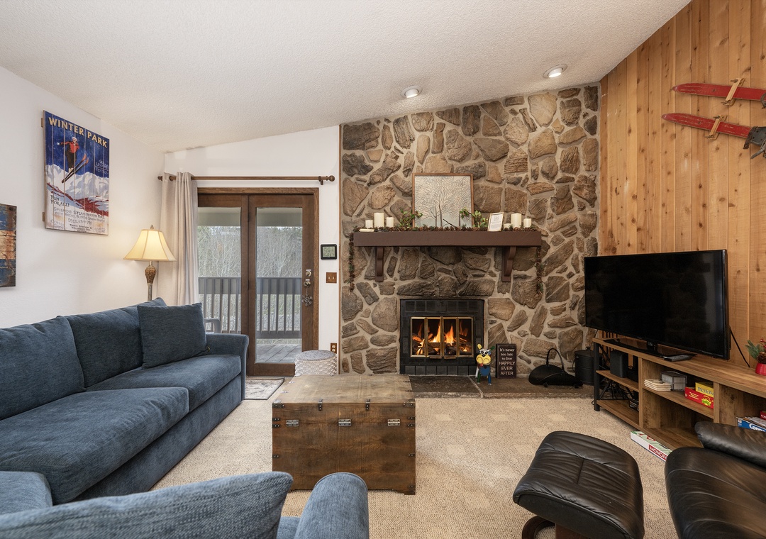 Cozy up in this inviting living room where crackling flames and plush seating create your perfect mountain retreat sanctuary.