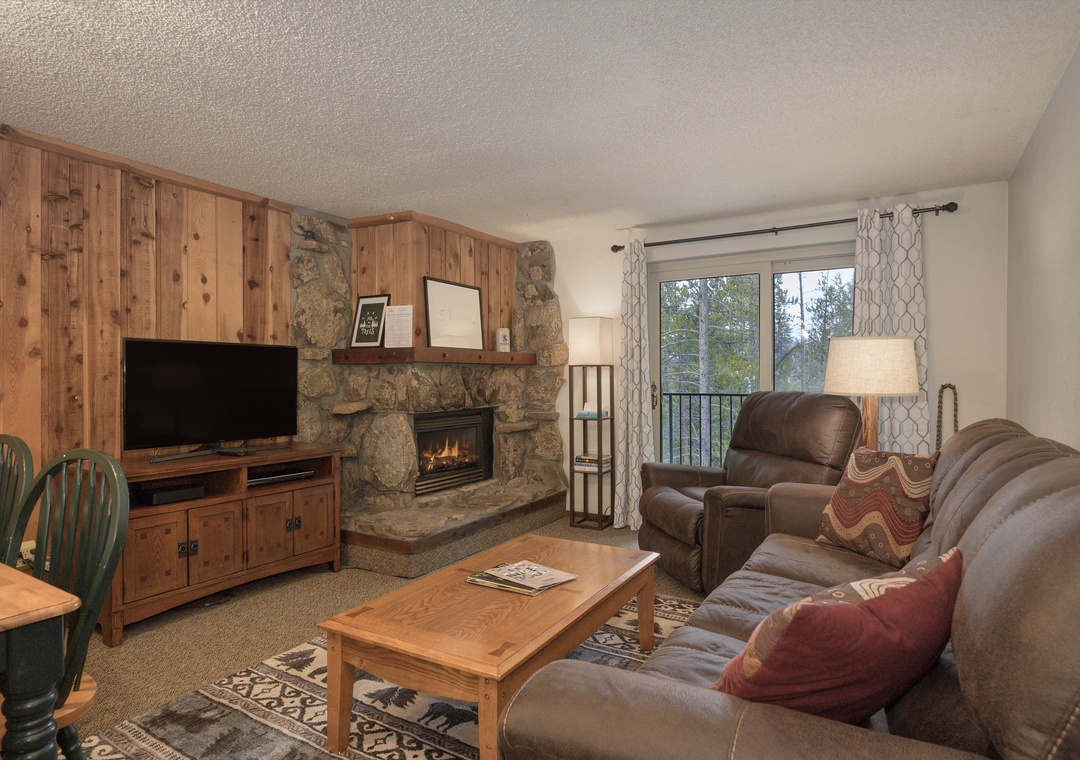 Cozy up by your crackling stone fireplace while watching your favorite shows on the flat-screen TV in this warm mountain retreat.