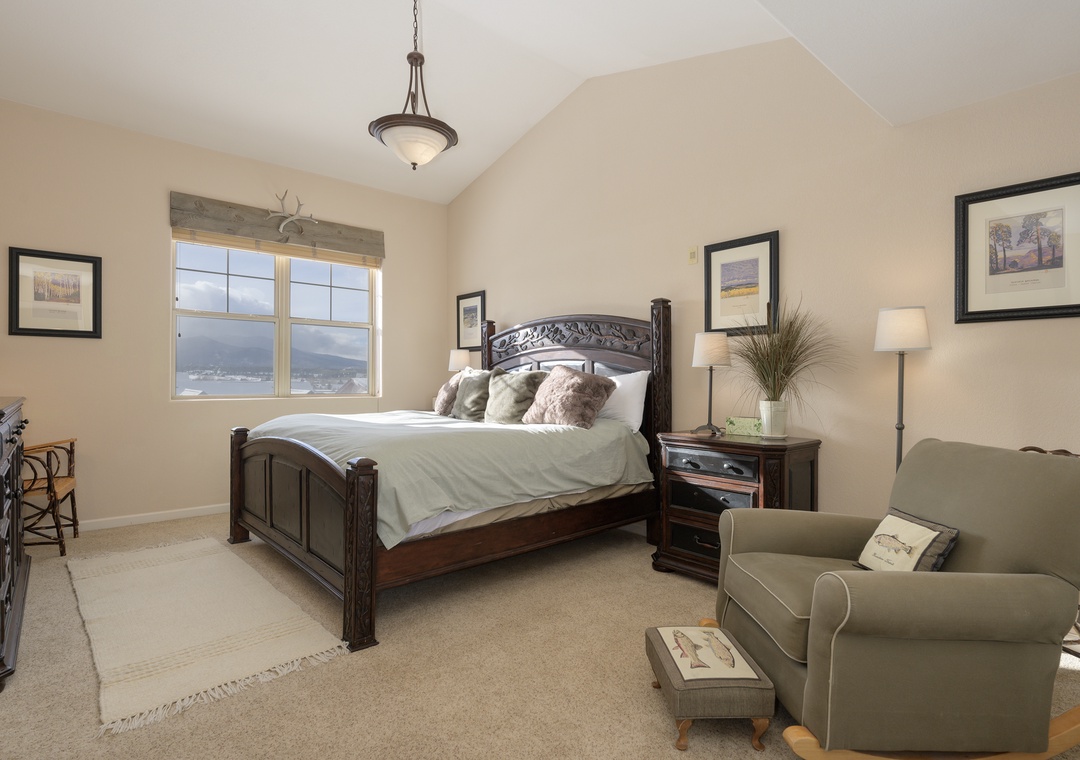 Relax in your serene bedroom with mountain views, plush bedding, and cozy seating area for quiet moments.