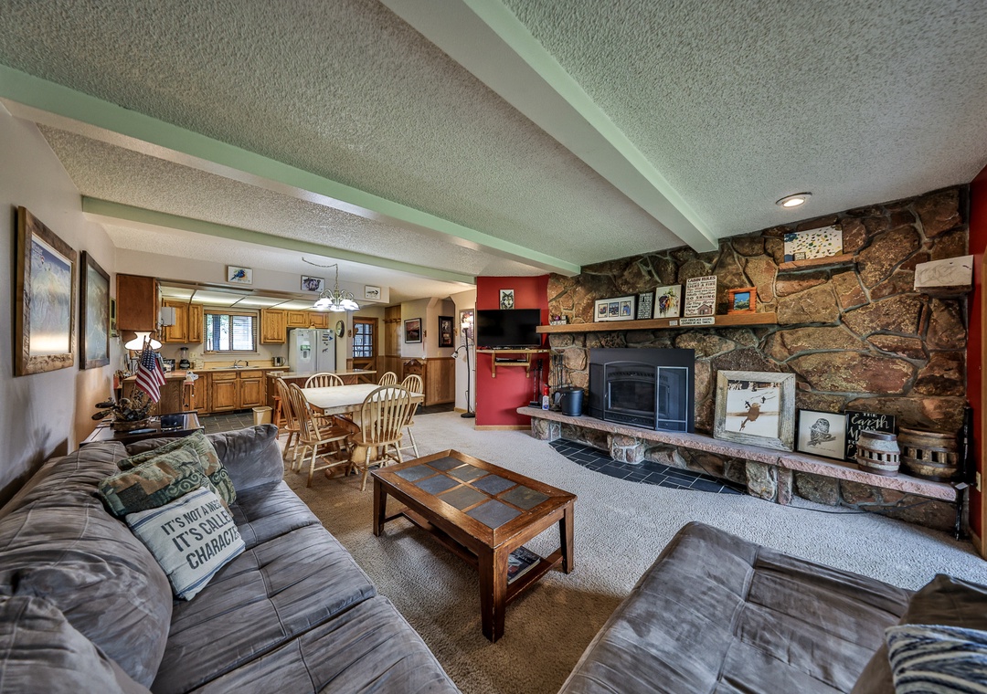 Sink into comfortable seating by your beautiful stone fireplace while enjoying the open-concept space that flows into your fully equipped kitchen.