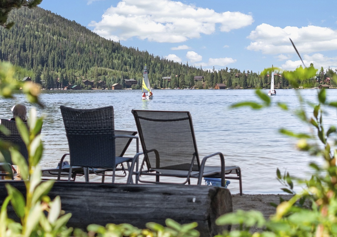 Picture yourself unwinding in your own lakeside lounge chairs, watching sailboats glide by as mountain breezes ripple the water. Your peaceful escape awaits at the edge of this stunning alpine lake.