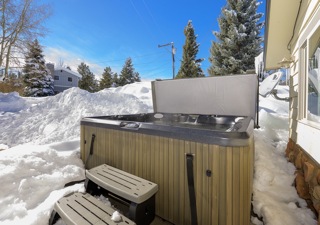 Soak in the bubbling hot tub while surrounded by pristine snow, creating the perfect winter retreat for ultimate relaxation.