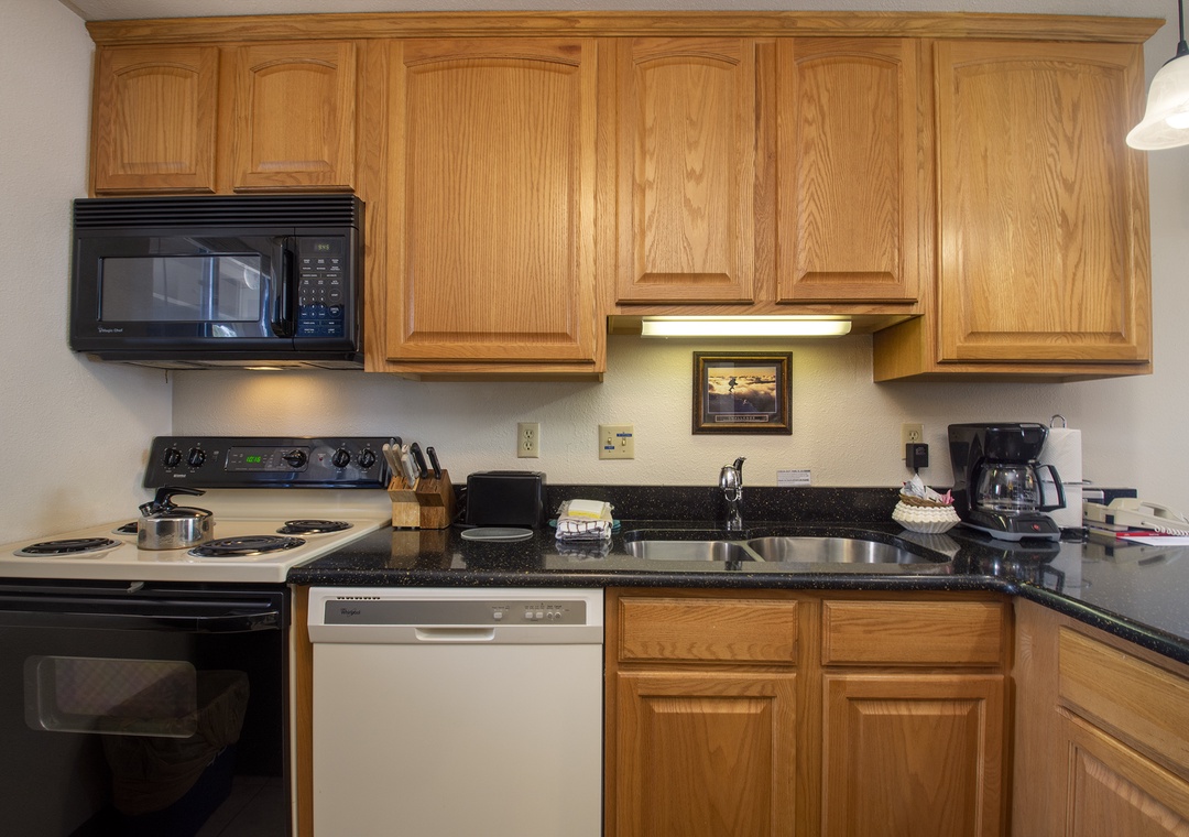 Your fully equipped kitchen features warm oak cabinets, granite countertops, and everything needed to prepare memorable meals during your stay.