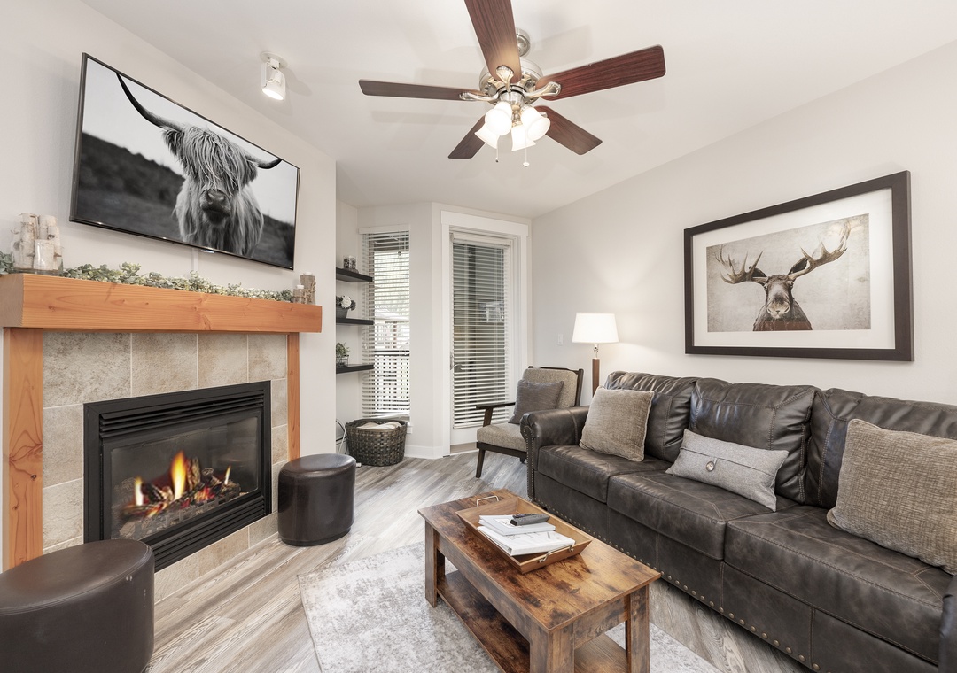 Cozy up in your stylish living room featuring a warm fireplace, plush leather seating, and thoughtful decor that creates the perfect mountain retreat atmosphere.