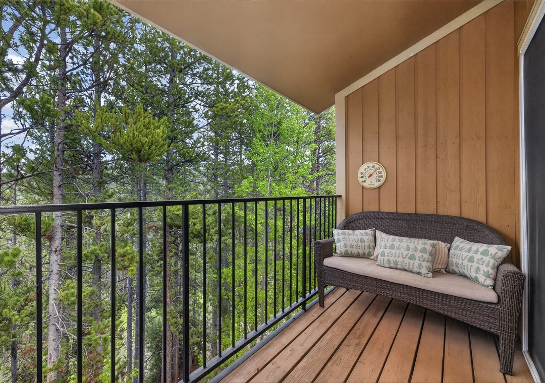 Settle into this cozy balcony nook and let the forest views refresh your spirit. With cushioned seating and lush greenery surrounding, it's your perfect spot to unwind.