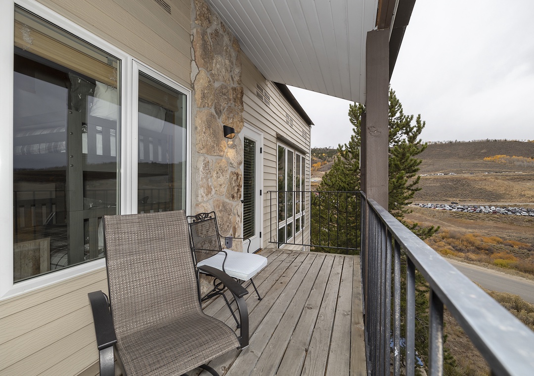 A covered deck overlooking expansive hillside terrain, perfect for quiet mornings with coffee or evening relaxation while taking in the natural surroundings.