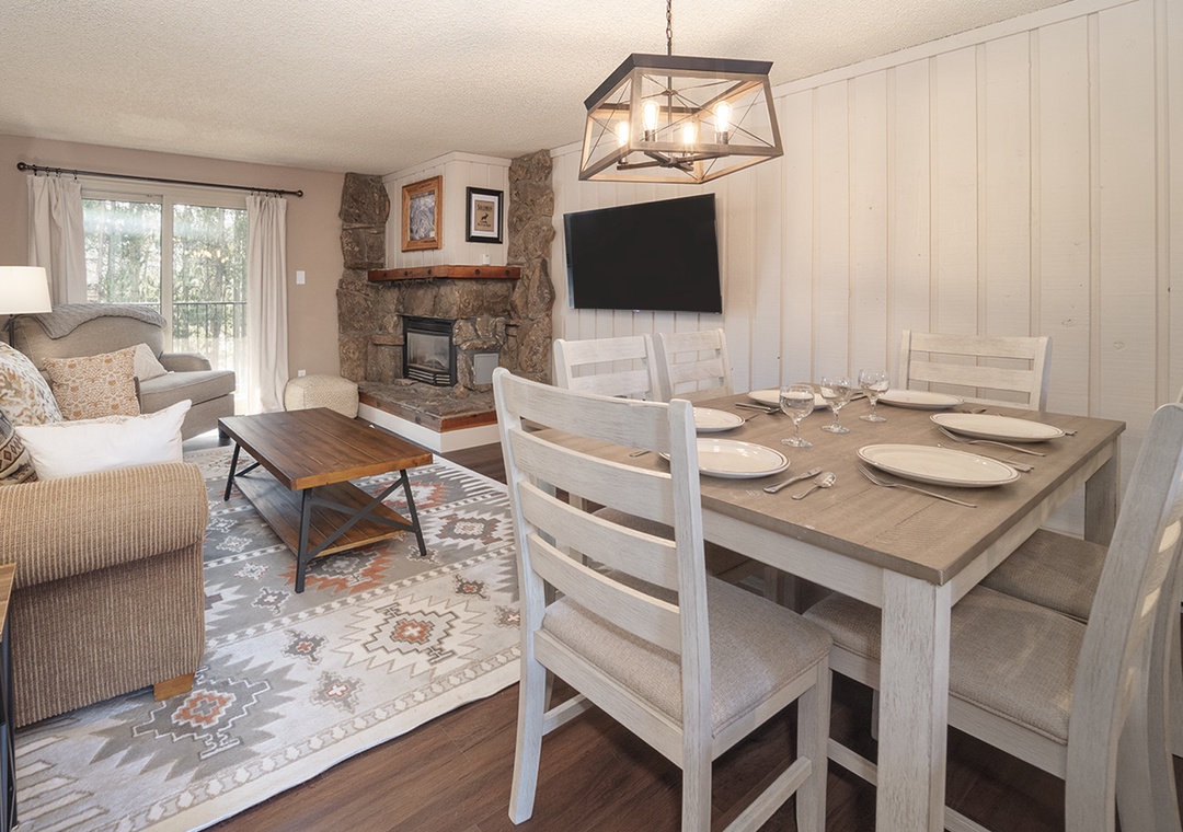 Gather around your dining table for memorable meals, with a cozy living area and warm fireplace creating the perfect atmosphere for relaxing evenings.