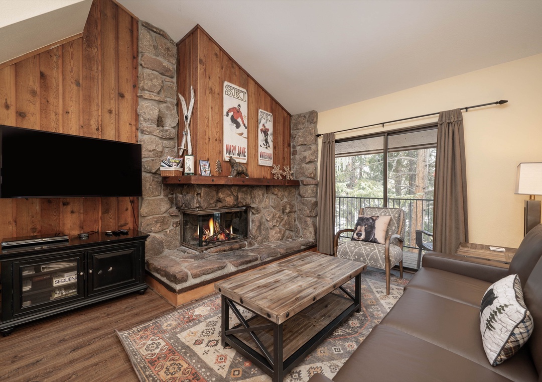 Cozy up by your crackling stone fireplace while enjoying mountain views from your private balcony in this rustic alpine retreat.