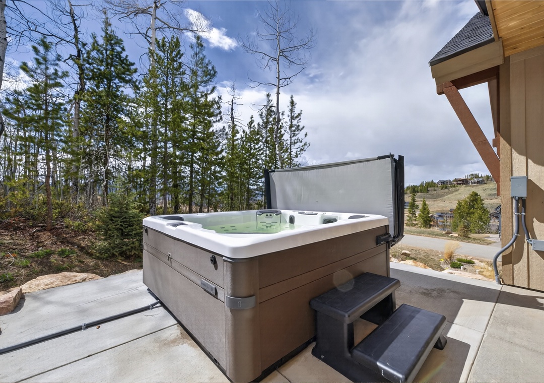 Soak away your cares in this private hot tub, surrounded by towering pines and mountain views—your perfect retreat after a day of adventure.