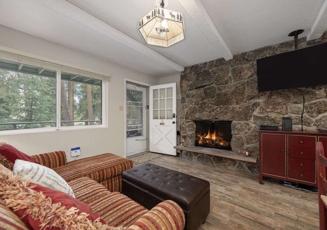 Cozy up by your crackling stone fireplace while forest views frame your mountain retreat through picture windows.