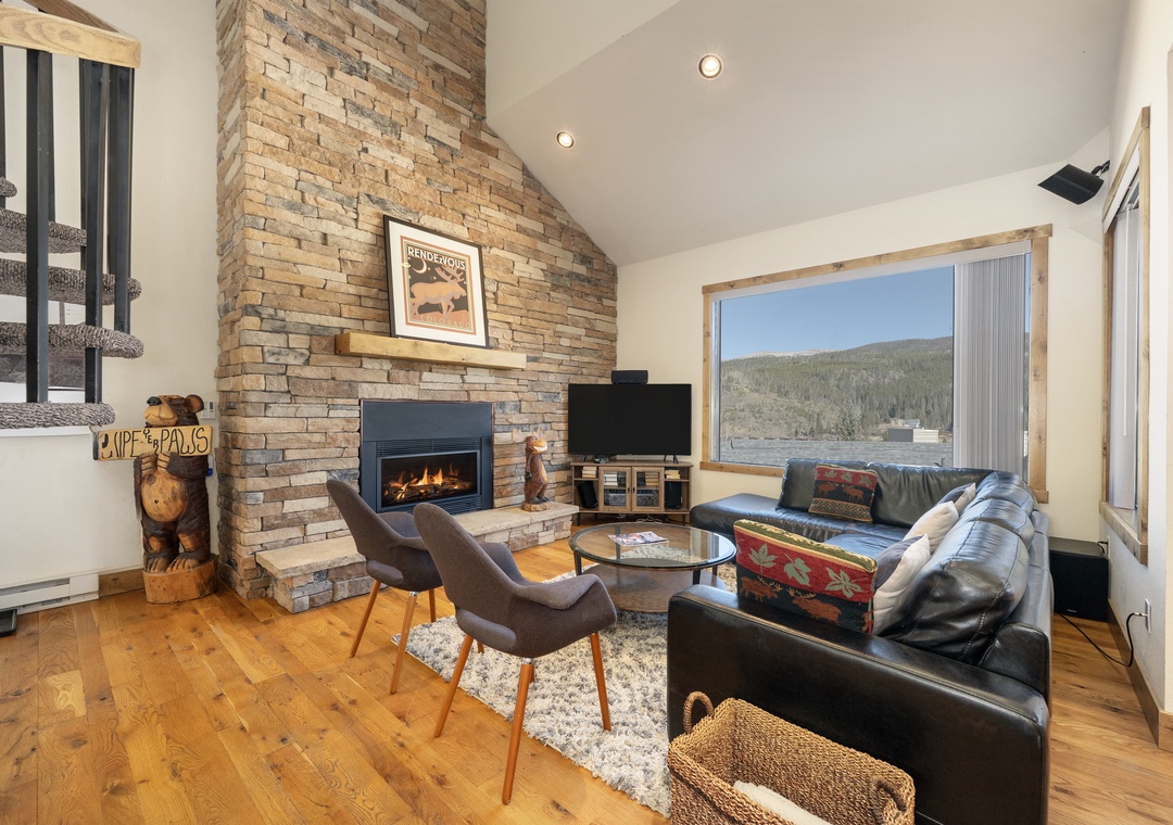 Cozy up by your crackling fireplace while soaking in stunning mountain views through floor-to-ceiling windows.