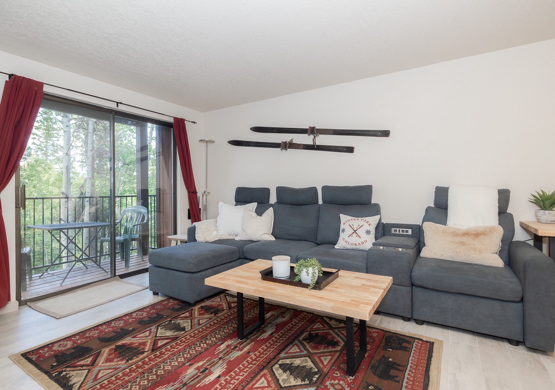 Sink into this cozy sectional and unwind while your private balcony offers peaceful forest views through floor-to-ceiling windows.