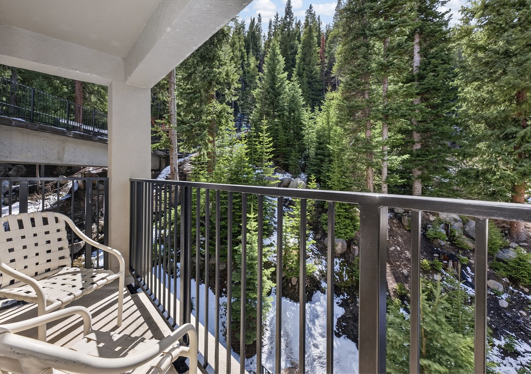 Unwind on your private balcony overlooking a serene forest of evergreens and rocky terrain, where fresh mountain air and natural beauty create your perfect retreat.