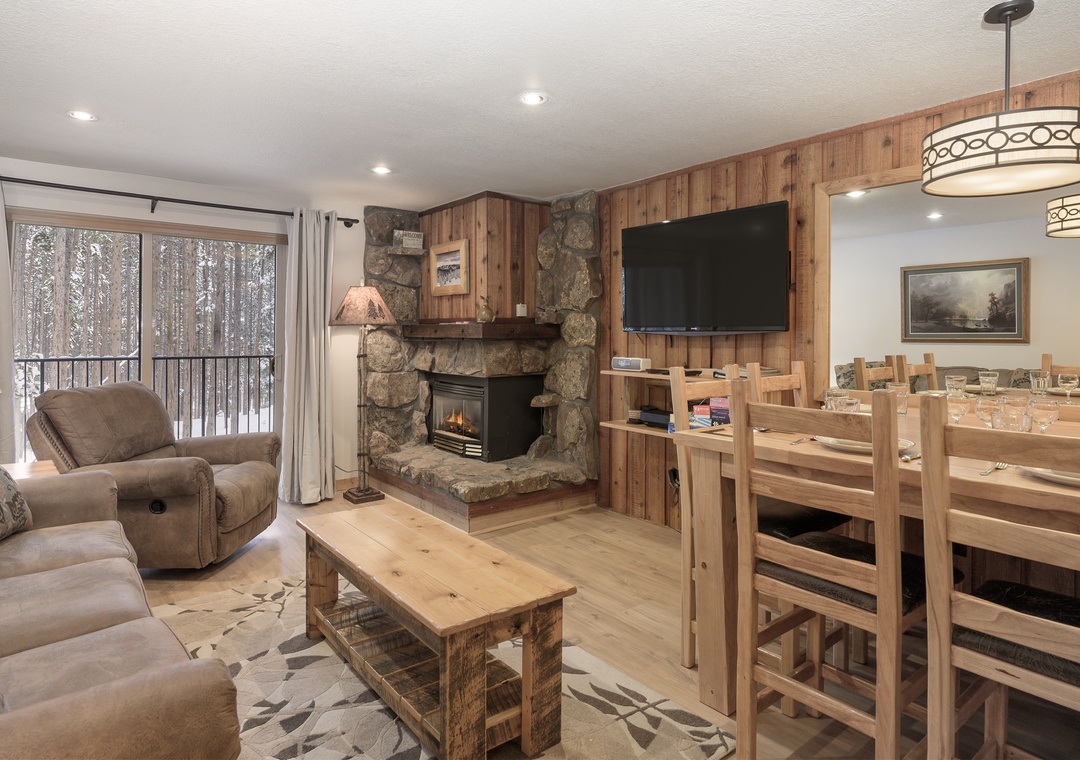 Cozy up by your stone fireplace while snow falls outside, creating the perfect winter retreat atmosphere.