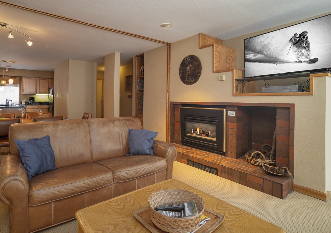 Cozy up by your fireplace with leather seating, watch skiing adventures on the mounted TV, and enjoy the open kitchen for perfect mountain evenings.
