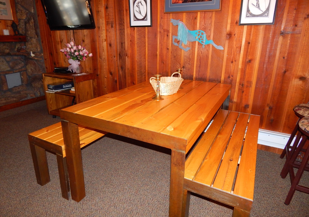 Gather around your rustic dining table where warm wood meets cozy cabin charm, perfect for sharing meals and making memories together.