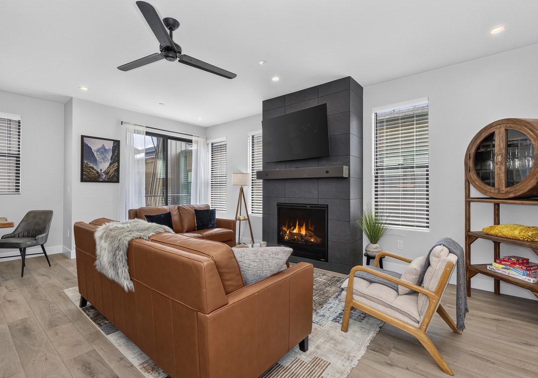 Sink into the plush leather seating and let the warmth of your gas fireplace embrace you in this thoughtfully designed living space, where modern comfort meets mountain charm.