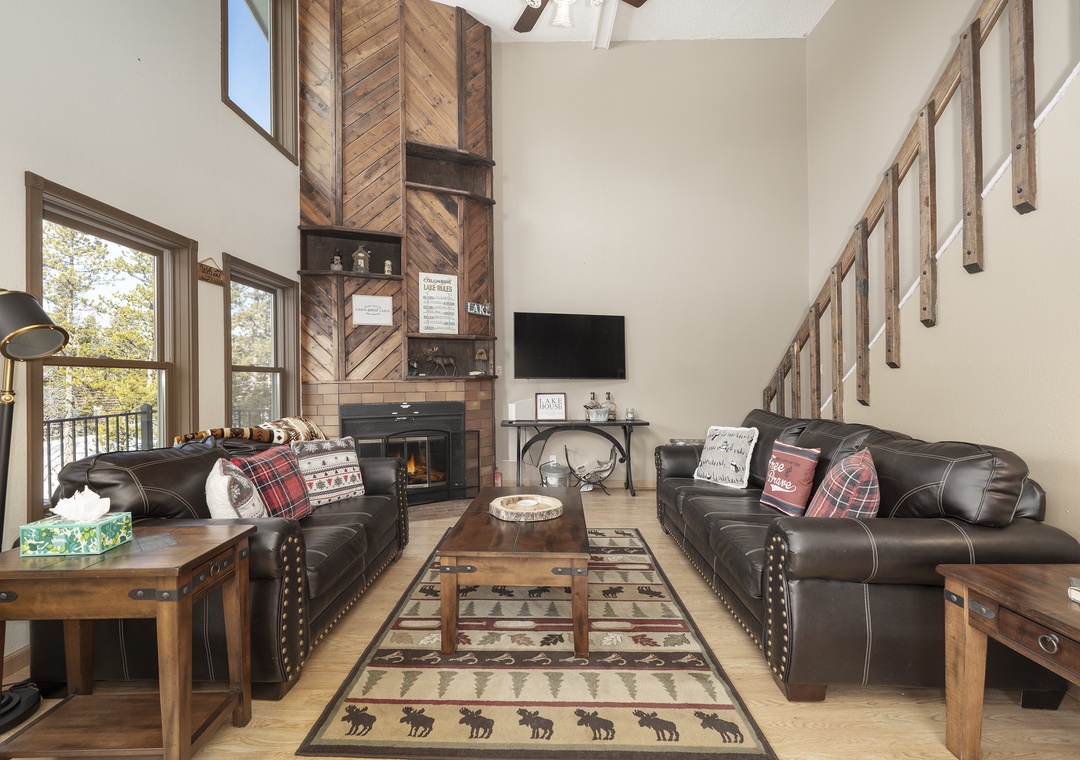 Sink into these plush leather sofas at 874 Kinnikinnick Road to enjoy your crackling fireplace, where rustic charm meets modern comfort in your mountain retreat.